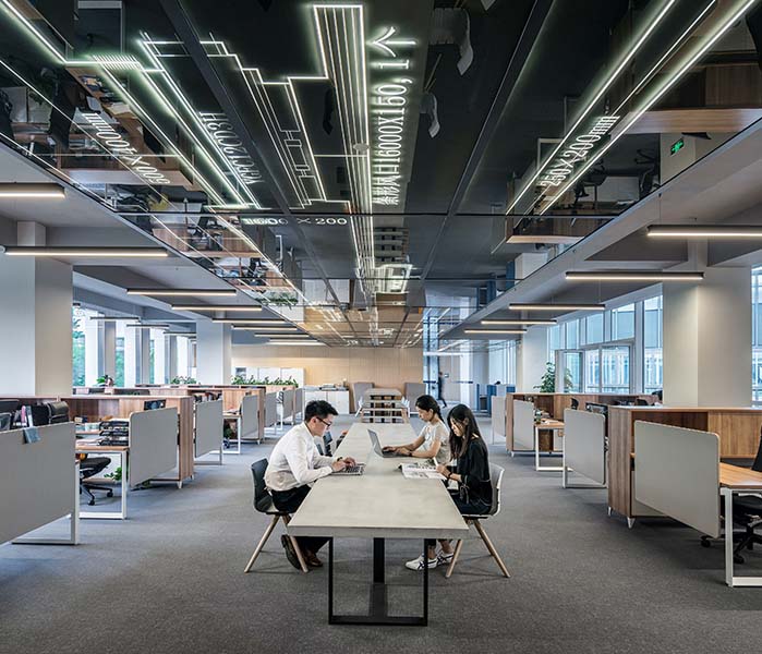 People working at a desk in an open office space