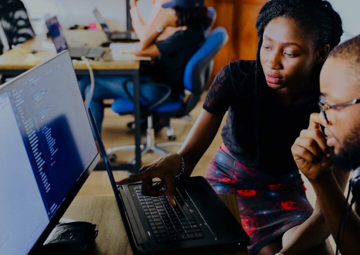 Two people sitting at a computer together