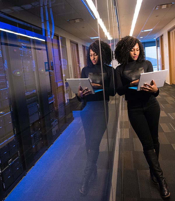 Woman leaning against server room wall