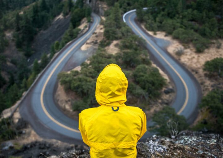 Person sitting looking down at a curvy road