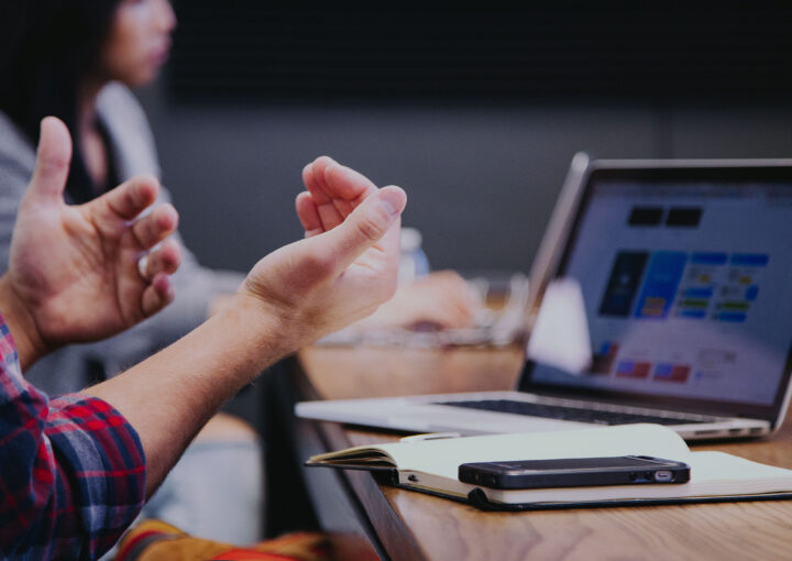 Man talking with hands while at a conference table