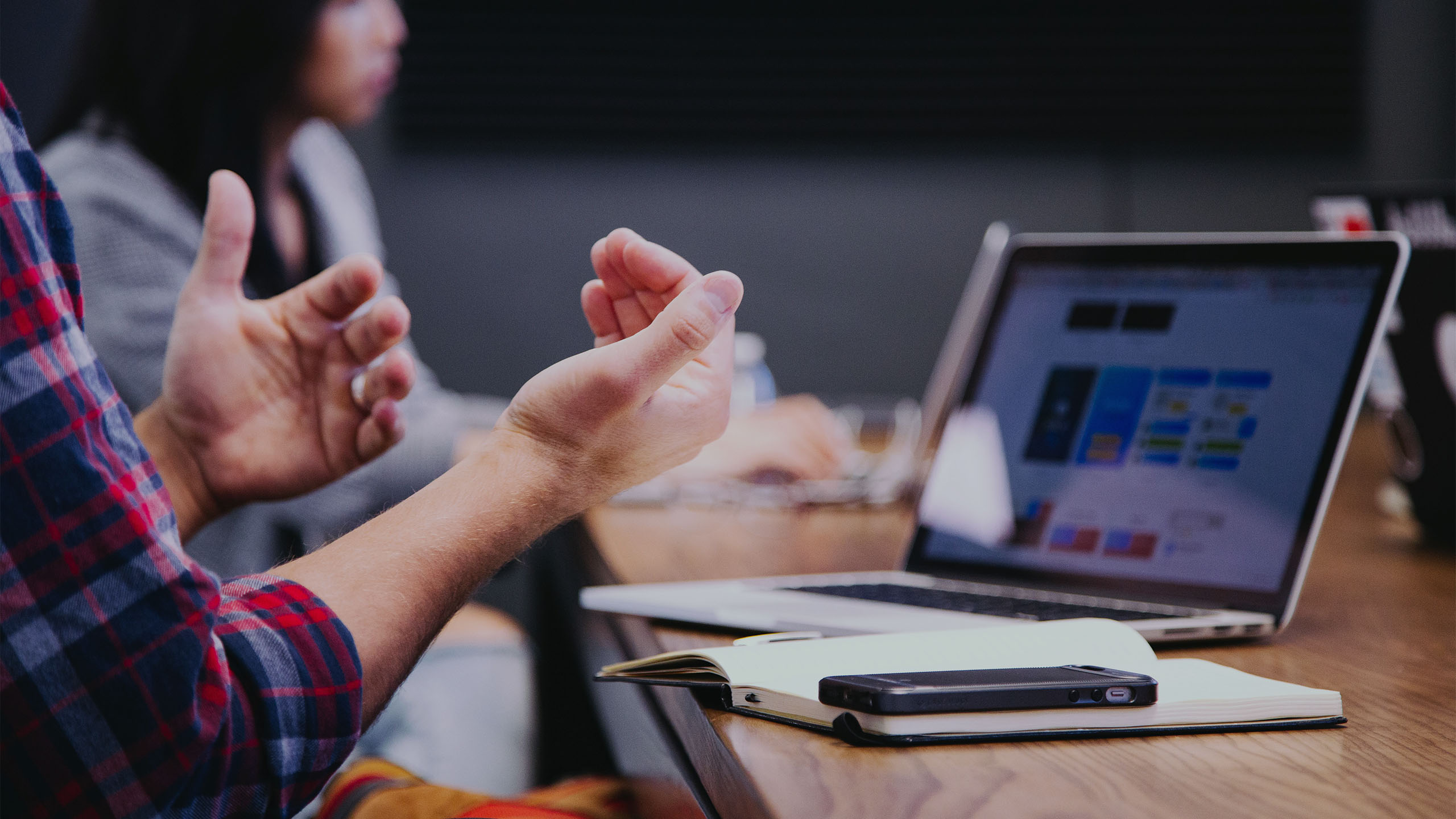 Man talking with hands while at a conference table