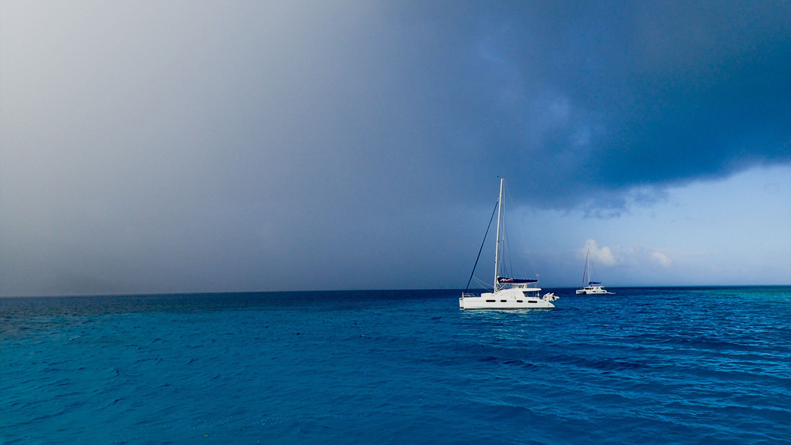 Image of the sky and a sail boat on the ocean